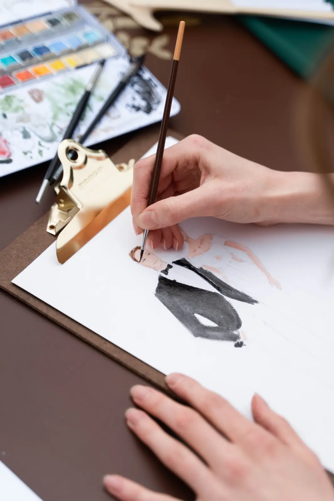 Eva Kovacik hand-painting an illustration